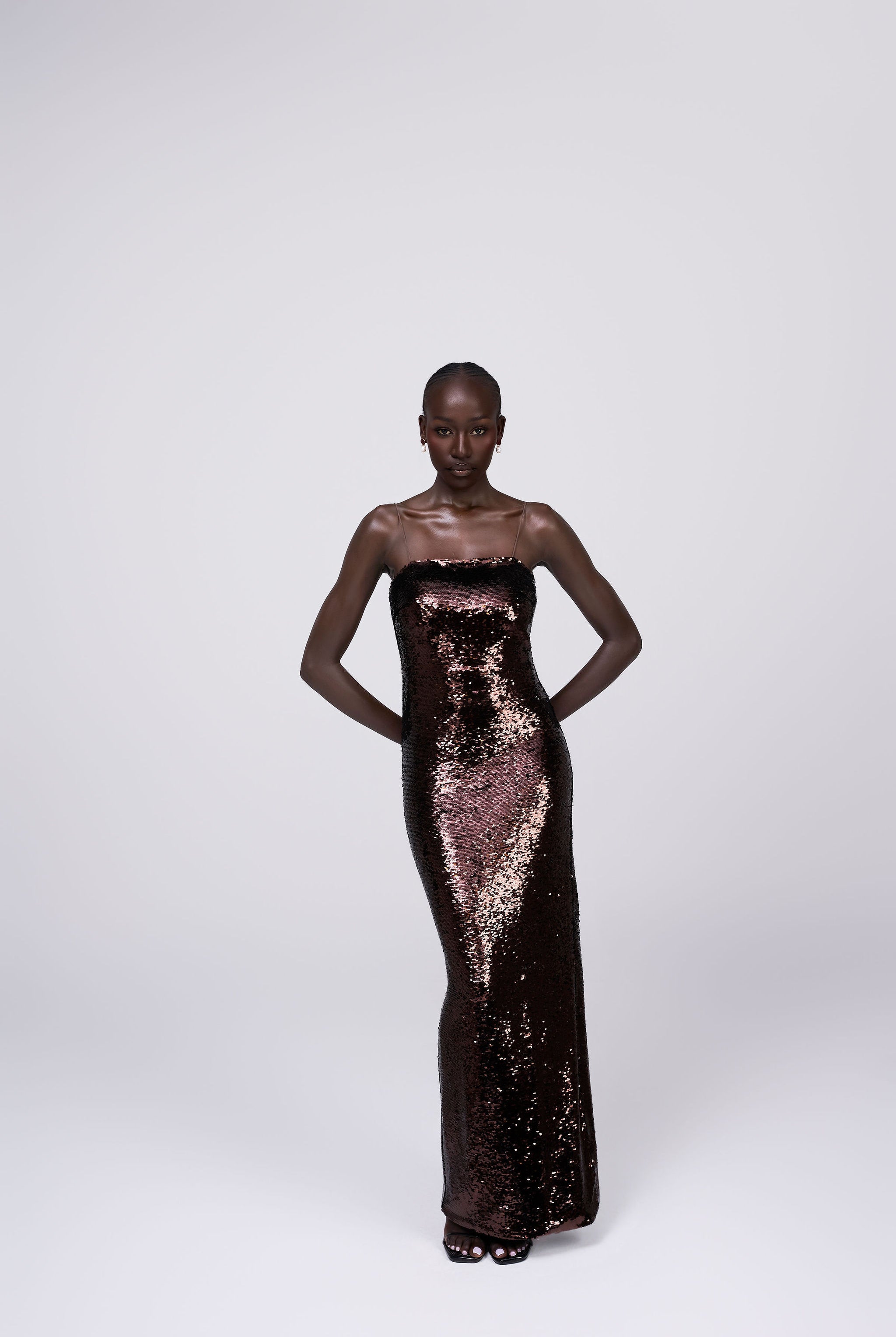 Giselle bronze chocolate brown sequin maxi dress grown spaghetti strap maxi gown front view
bronze sequin occasion gown lifestyle shot Australian luxury eveningwear
