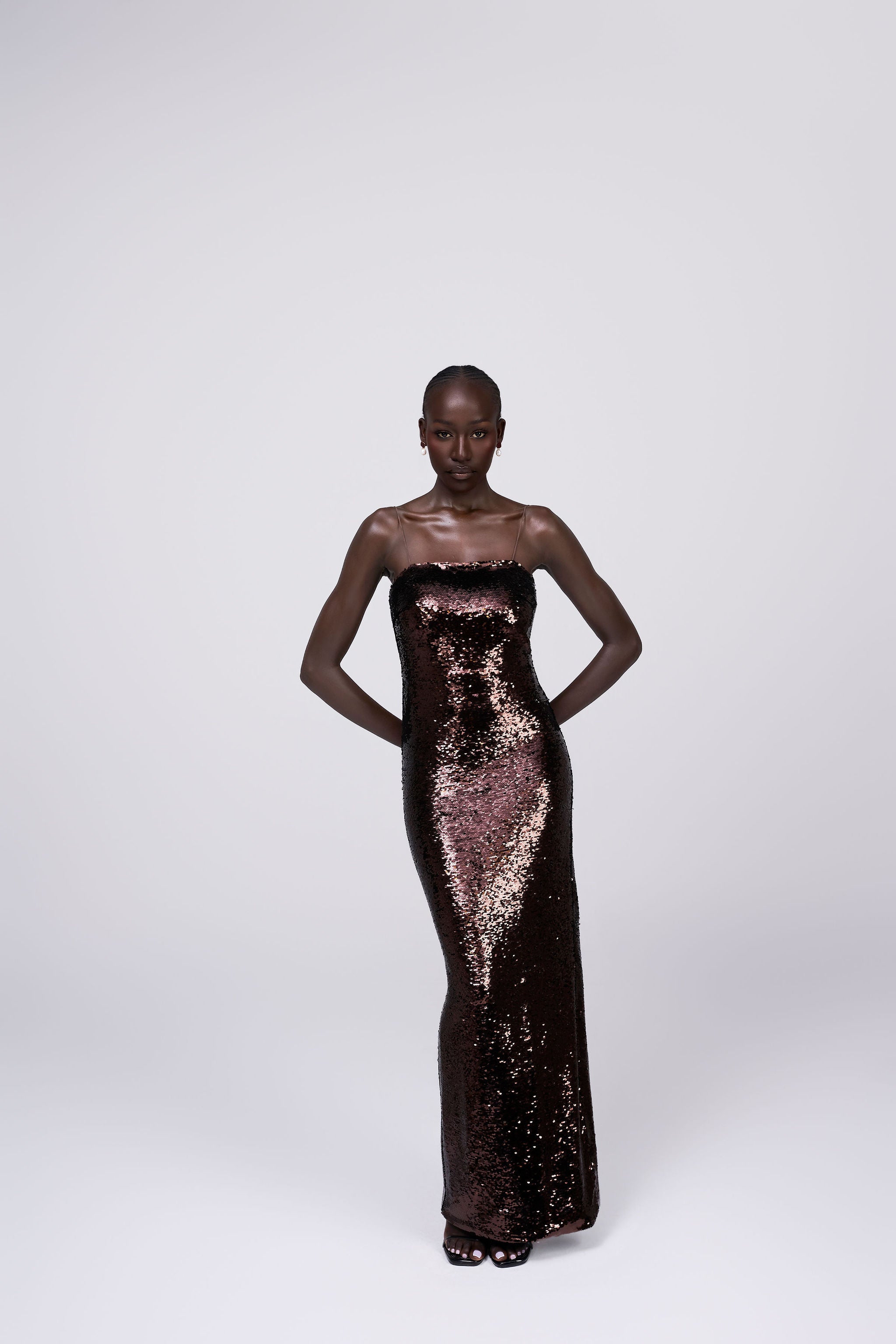 Giselle bronze chocolate brown sequin maxi dress grown spaghetti strap maxi gown front view
bronze sequin occasion gown lifestyle shot Australian luxury eveningwear