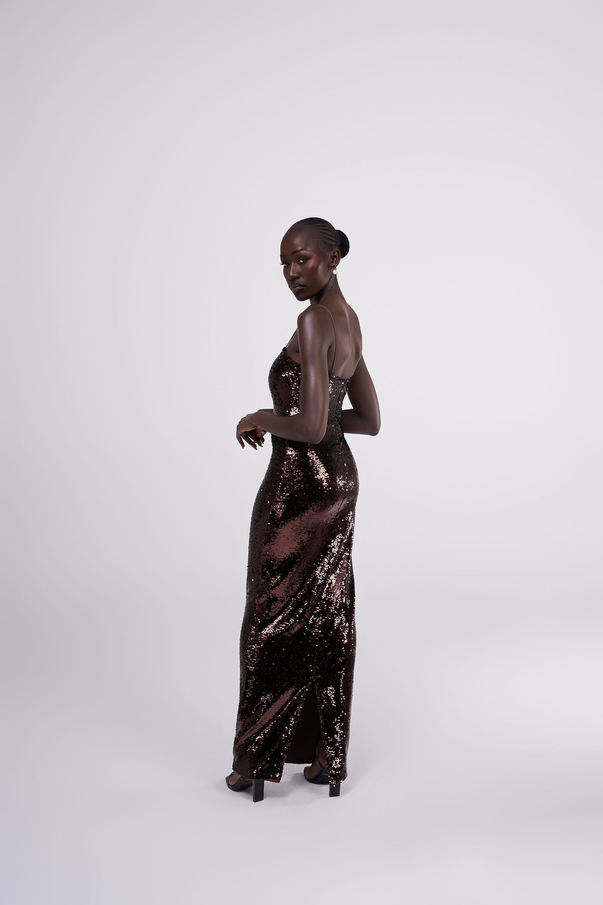 Giselle bronze chocolate brown sequin maxi dress grown spaghetti strap maxi gown front view
bronze sequin occasion gown lifestyle shot Australian luxury eveningwear